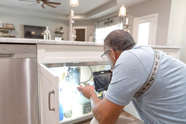 inspecting under sink in kitchen inspecting under sink in kitchen